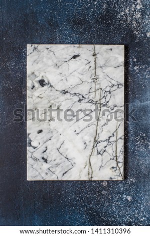 Marble Board on Dark Blue Concrete Background, copy space for your text