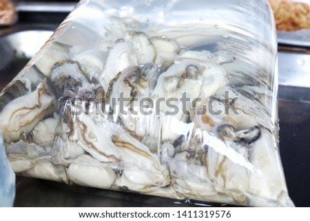 Too soft, Fresh Oysters in bag stuffing for sale in the market, ready for sending to restaurant use for cook, Selective focus