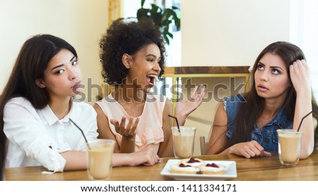 Annoying talkative friend sitting in cafe with girls and storytelling, her friends boring, panorama, empty space, concept Royalty-Free Stock Photo #1411334171