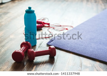 Sport equipment isolated on wooden floor at home healthy lifestyle