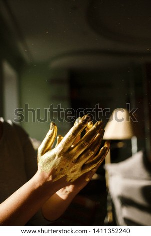 
Golden hands on a dark background concept of skilled fingers. Hands of a creative person with talent in any field, hands of a talented person