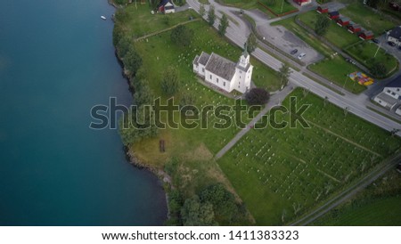 Oppstryn Church and its graveyard, in Norway, on the shore of Oppstrynsvatnet lake