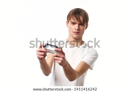 Handsome man holds in his hands a joystick game console fun delight