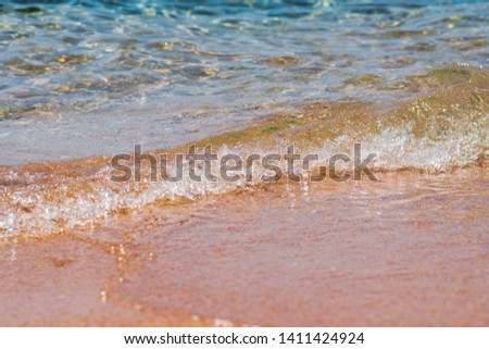 Closeup photo of sea waves rolling on the sandy sea beach. bokeh background.
