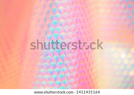Iridescent futuristic pop spectrum candy colored abstract wallpaper background texture with glowing hexagon pattern and synthetic material Royalty-Free Stock Photo #1411431164