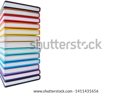 A lot of books with bright covers in one pile isolated on white background. Place for text. Design element, paper and leather texture