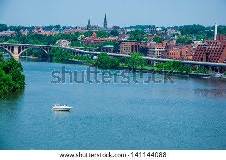 Washington DC by the Potomac river. elevated view of Washington DC by the Potomac river. In the picture are Key bridge, and Georgetown waterfront park and harbor.