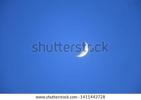 Moon: a waxing moon in clear blue sky 