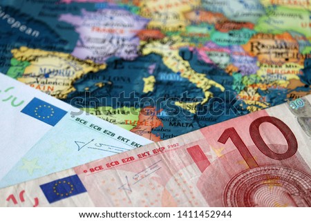 Euro banknote on the Europe map. Concept for Eurozone, European economy, stock market in EU Royalty-Free Stock Photo #1411452944