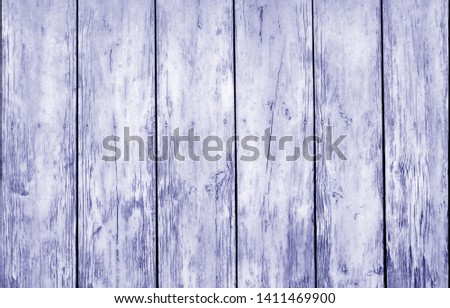 Weathered wooden fence in blue color. Abstract background and texture for design.
