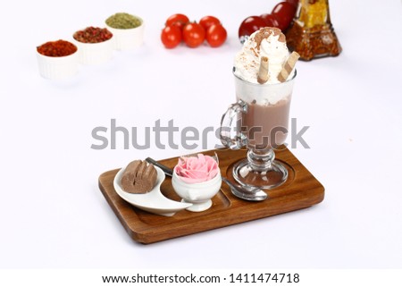 coffee latte macchiato with whipped cream in tall glass on served
