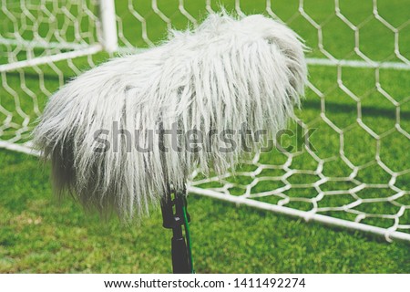 Professional sport microphone on a soccer field behind the net
