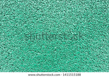 Green granules for background. Texture of green outdoor sports flooring.