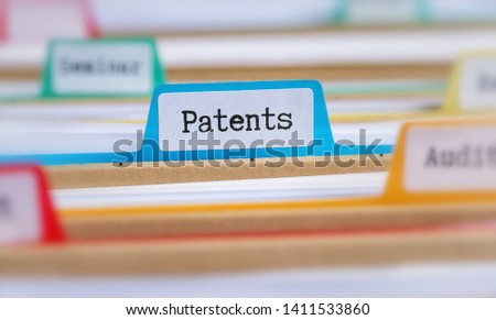 File folders with a tab labeled Patents Royalty-Free Stock Photo #1411533860