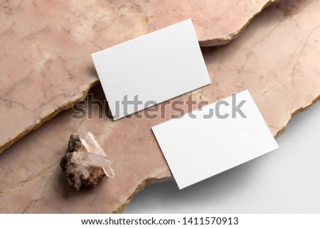 Real photo, business cards branding mockup template, isolated on light grey background, with marble and floral elements to place your design.