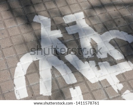 bicycle symbol, painted on the bicycle lane on the street of a city