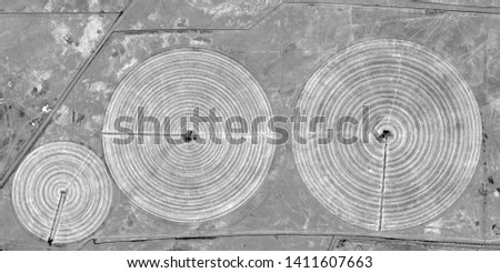 The power of the wind, allegory, abstract naturalism, Black and white photo, farms of human crops in the desert, abstract photography of landscapes of the deserts of Africa from the air, aerial view, 