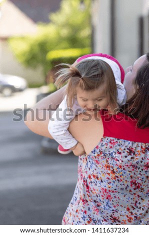 Portrait of loving mother who playing with her daughter. Awesome family moments. Outdoor photography
