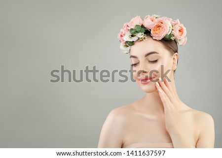 Beautiful face. Healthy woman with clear skin and flowers