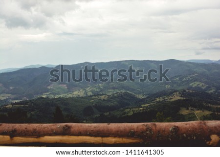 Mountain views with a wooden house and silhouettes of people.