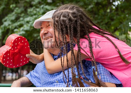 Granddaughter and her mother giving present ( surprise ) to her father ( Happy father’s day )
Surprise, happy father’s day at the park
