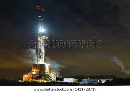 The beautiful sunrise landscape of Drilling rig in onshore oilfield of Russia. Oil drilling rig operation on the oil platform in oil and gas industry.