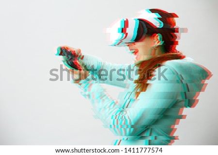 Woman with virtual reality headset is playing game. Image with glitch effect.
