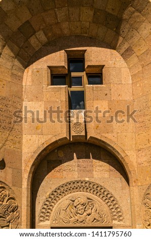 The window in the form of a cross on the facade of the Church of the Holy Martyrs in the village Teghenik the Kotayk province of Armenia