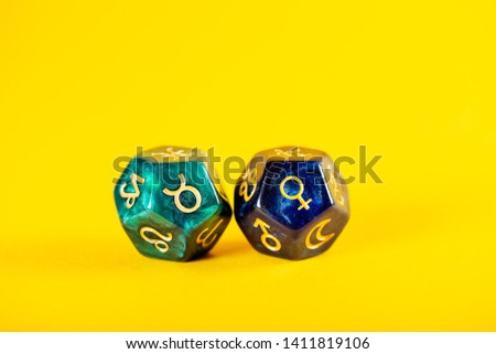 Astrology Dice with zodiac symbol of Taurus Apr 20 - May 20 and its ruling planet Venus on Yellow Background