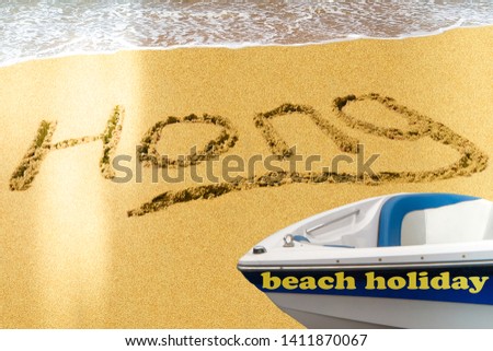 Hong title on the sand beach of the South China sea. The white boat stands on the shore.