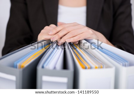 Midsection of businesswoman with binders at office Royalty-Free Stock Photo #141189550