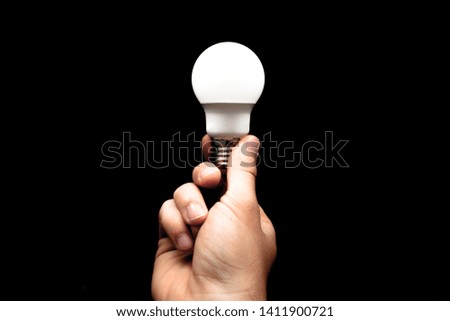 Brainstorming bulb creative idea abstract icon in business hand. Work of companies, black background. Ideas