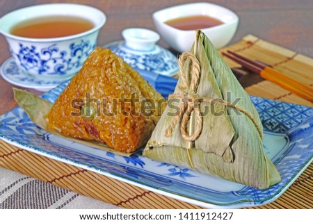 Sticky rice dumpling or Zongzi (Pyramid-shaped dumpling made by wrapping glutinious rice in bamboo leaves) Tradition food for Chinese Boat dragon festival (5th Lunar month festvial, Duanwu festival)