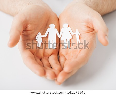 man hands showing family of paper men