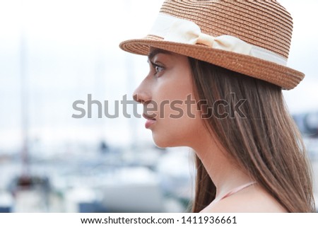 portrait of a young woman in a hat in profile, the dream of a sea trip, lifestyle concept