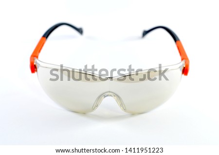 Safety glasses are used to working in chemical plants or construction projects. The color of the lens is light brown colored and has a white background.