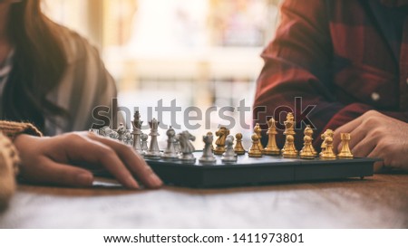 Closeup image of people playing chessboard game together