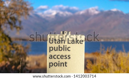 Panorama Utah Lake Public Access Point sign on a grassy terrain viewed on a sunny day