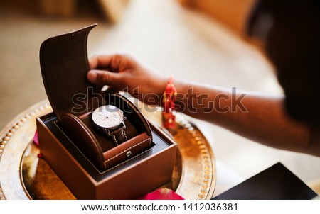 Indian groom looking at wedding watch Royalty-Free Stock Photo #1412036381