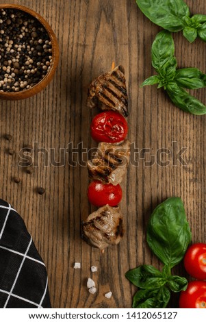 Grilled meat skewers on wooden board with vegetable salad– stock image