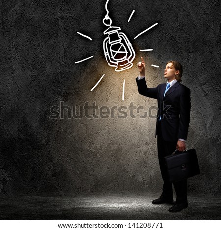 Image of businessman in black suit against dark background