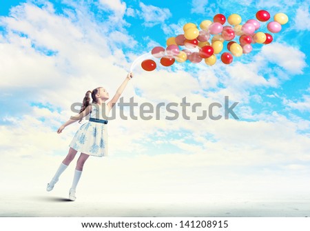 Image of little pretty girl playing with balloons