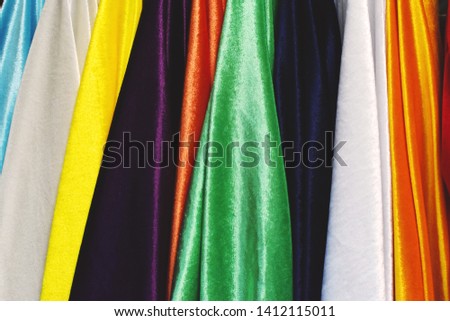 Row of multi color flannel clothes fabric sale display for choose at store in various color as white, violet, green, dark blue, orange, red sign colors of LGBTQ concept 