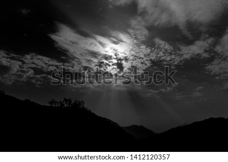 Beautiful blazing sunrise landscape at over the sky above it. Amazing summer sunrise as a background. Black and white beautiful picture 