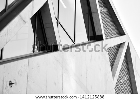 Modern architecture detail. Refined fragment of  office building. Concrete cellular structure.Contemporary office building. Abstract lines on architecture. Black and white.