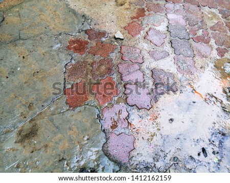 Patterned damaged street tiles. Texture. Abstract background.