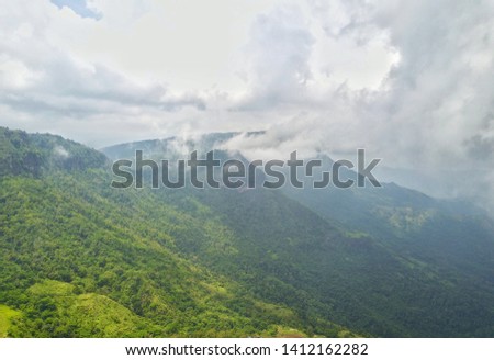 Beautiful green mountains and fog in the winter in Thailand.