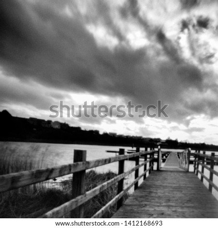 jetty at the river erne, enniskillen, fermanagh,, this black and white photo is NOT sharp due to camera characteristic. Taken on analogue photographic medium format film with a pinhole camera.