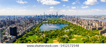 Central Park aerial view, Manhattan, New York. Park is surrounded by skyscraper. Beautiful view of the Jacqueline Kennedy Onassis Reservoir in the center of the park. Royalty-Free Stock Photo #1412172548