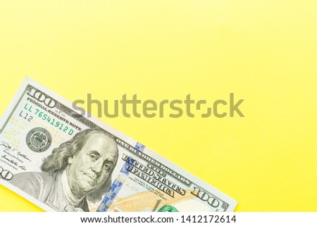 One hundred dollar bills cash lying on yellow background . Financial and business concept. Flat lay, mockup, overhead, minimalism